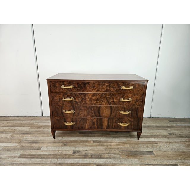 Art Deco walnut chest of drawers with four drawers and finely crafted Bakelite and brass handles. This chest of drawers is...