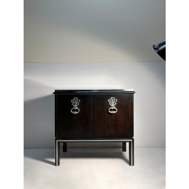 Vintage 1970s Petite Cabinet with large Decorative Bohemian Pulls. The top is a metal. Cabinet makes for a nice Bar...