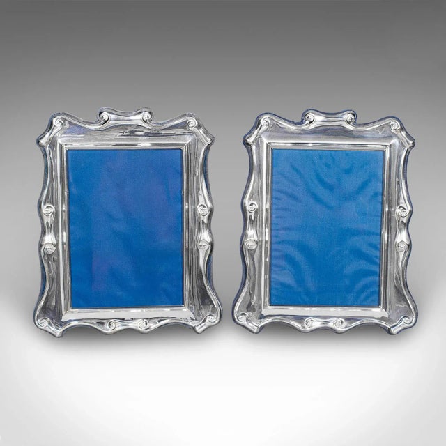 This is a pair of vintage picture frames. An English, silver plated 5x7 ratio photo display, dating to the Art Deco...