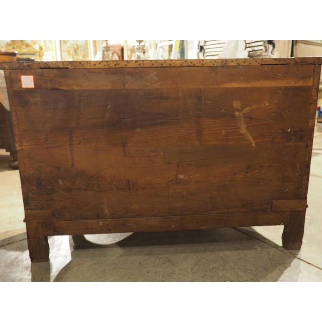 This unusual two-drawer walnut commode with iron pulls from France exudes charm. Hand-carved from walnut wood in the...