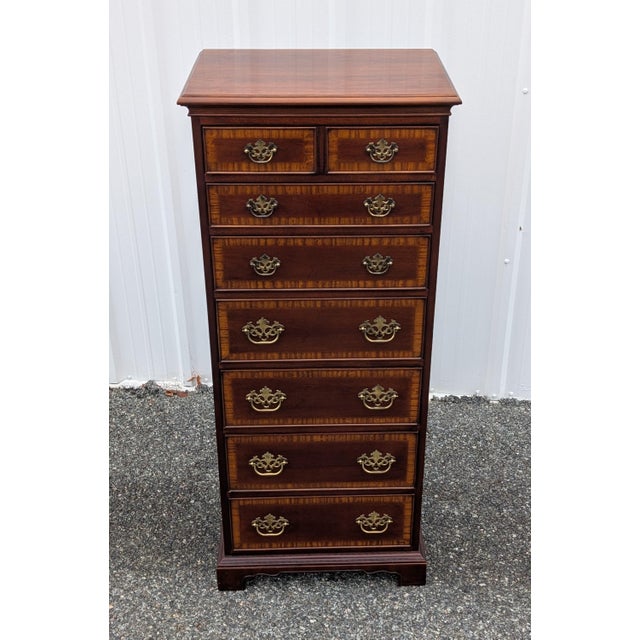 Elevate your interior with this exceptional Drexel Heritage Georgian-style tall chest, expertly crafted from rich,...