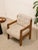 A wonderfully substantial vintage armchair with a chunky exposed wood frame and beautifully textured cream upholstery.