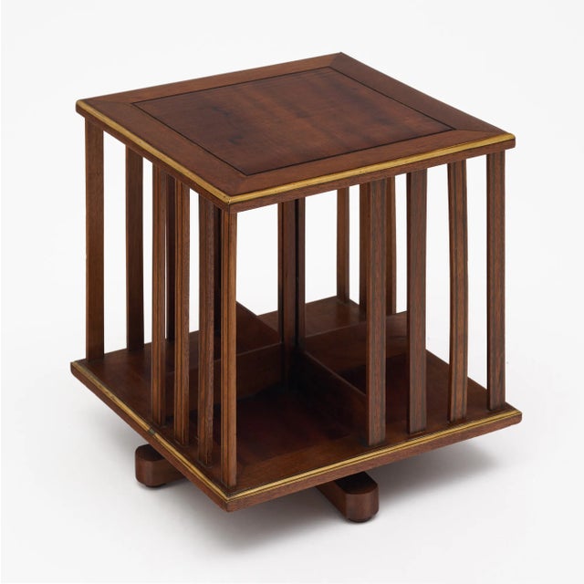 Small bookcase made of solid wood construction, primarily mahogany. This antique piece has four compartments for holding...