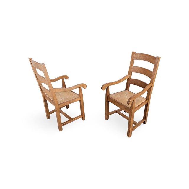 We are offering a beautiful set of two French oak armchairs from the 1950s-60s for sale. The chairs feature hand-woven...