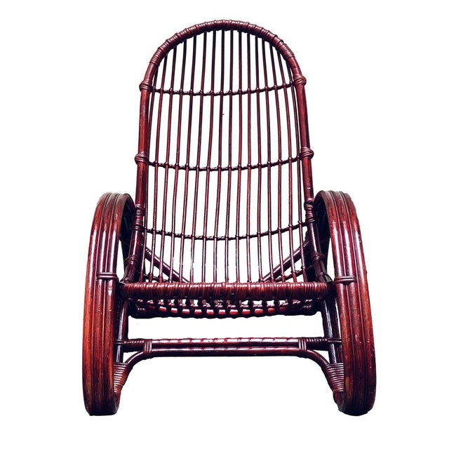 Elegant and enveloping dark brown bamboo and rattan armchair from the 1960s, light signs of use consistent with age. This...