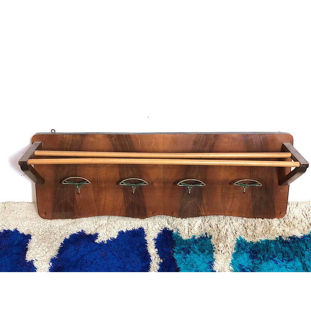 Coat rack with hat rack from the 1950s, made entirely of beech wood and featuring four brass hangers. There are small...