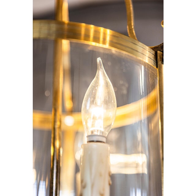 This elegant early 20th-century French lantern showcases a beautifully crafted brass frame with delicate curved supports,...