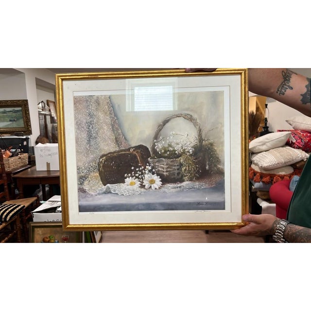 A soft, romantic still life print featuring woven baskets filled with delicate white flowers, daisies, and intricate lace...