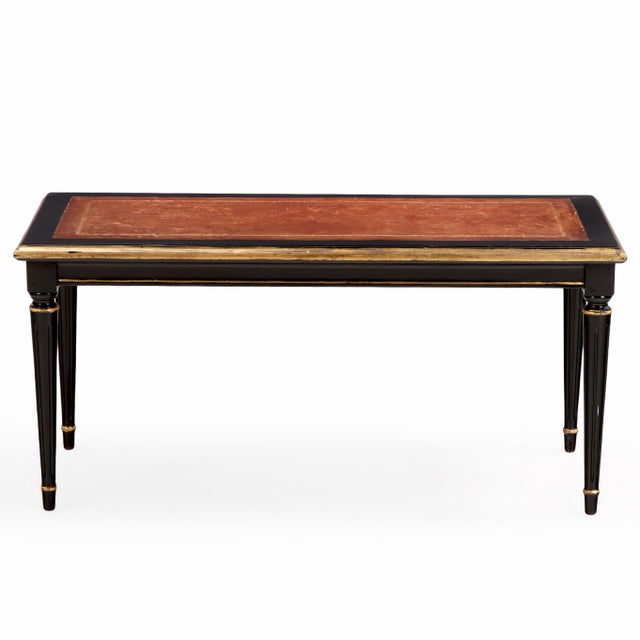 Mid-century French coffee table by Maison Jansen, circa 1940s, featuring a leather inset top within a dark lacquered frame...