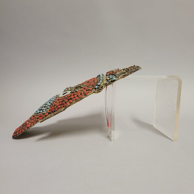 A vibrant vintage wall mask of Lord Ganesh, the elephant-headed Hindu deity, remover of obstacles and bringer of...