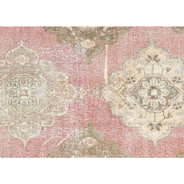 This Vintage Turkish Oushak Rug, measuring 4'8" x 12'8", is handwoven with wool on a wool foundation in Western Turkey’s...