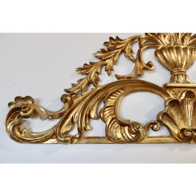 A vintage handmade wall ornament in aged gold gilt, styled after the scrolling acanthus and shell motifs of Italian...