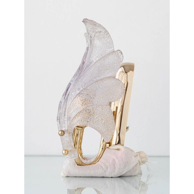 This sculptural mid-century Murano wall sconce features two hand-blown graniglia glass leaves mounted on a polished brass...