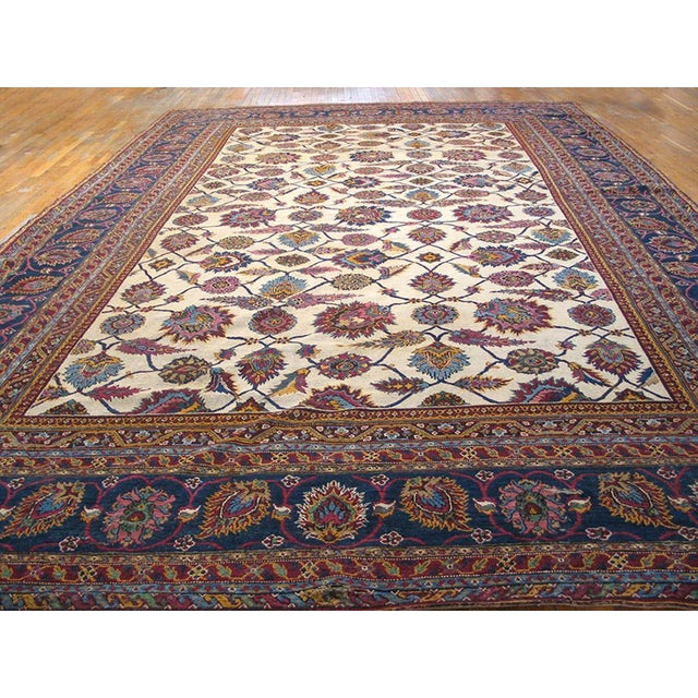 Antique Indian Agra rug, measures: 11' 0" x 16' 9". This ivory background large-scale allover tribal floral design antique...