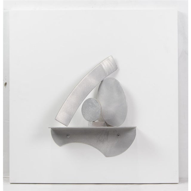 An elegant and wall-mounted abstract sculpture by renowned American sculptor Guy Dill, created in 1997. Composed of...