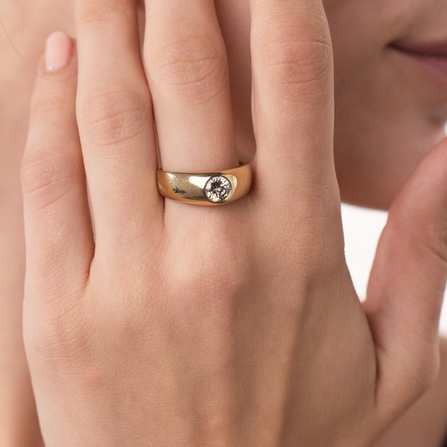 This elegant vintage diamond engagement ring is a timeless 1970’s design, centered by a round brilliant cut diamond...
