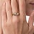 This elegant vintage diamond engagement ring is a timeless 1970’s design, centered by a round brilliant cut diamond...