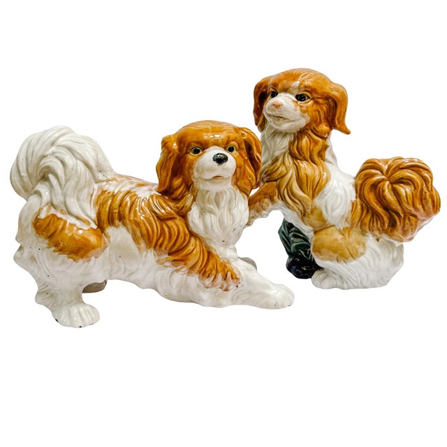 Expressive pair of vintage, heavy-set ceramic Cavalier King Charles Spaniel or Pekingese dog figurines. Crafted from a...