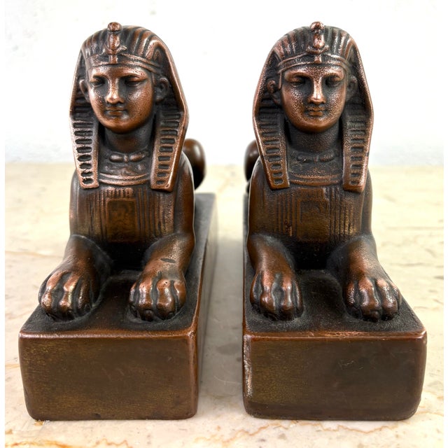 This is a pair of early 20th century copper sphinx sculptures. This pair of sphinxes have a stone form with hand hammered...