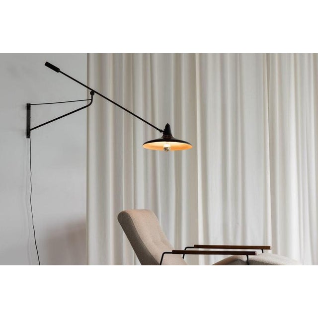 This rare and early wall lamp model 3030 was designed and manufactured by Stilnovo in Italy around 1950. The piece...