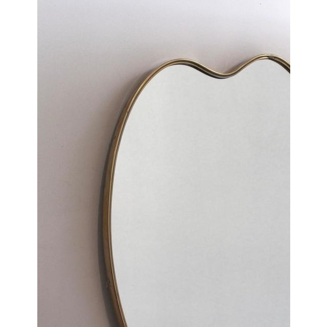Mid-Century Italian wall mirror with brass frame (circa 1960s). This mirror is simply elegant and characterful in a...