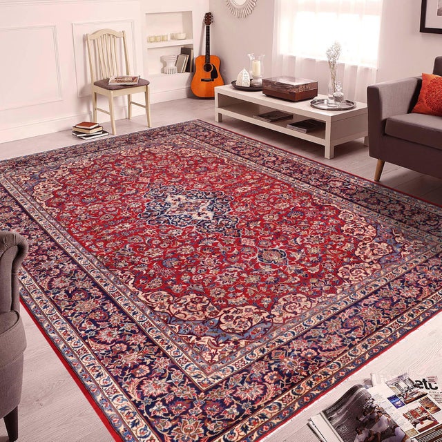 Transform your space with this vintage antique-style, hand knotted Persian Kashan wool rug in red and blue. Made by hand...