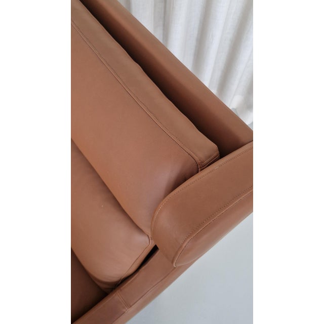 Børge Mogensen wingback chair re-upholstered with walnut elegance leather. Legs in teak. Model 2204, re-upholstered by...