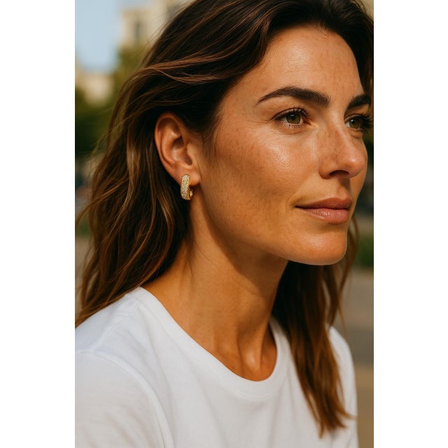 Classic and radiant, these 14K yellow gold half hoop earrings are set with a dazzling row of diamonds totaling 1.30...