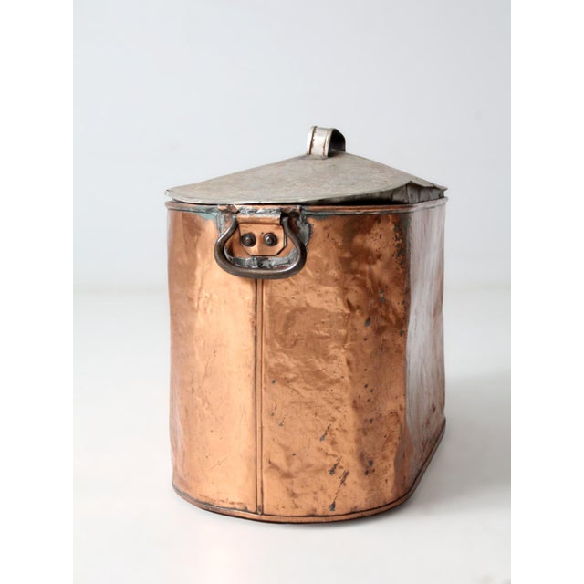 Antique copper wash tub from the late 19th to early 20th century, featuring an oval basin, fitted lid, and original side...