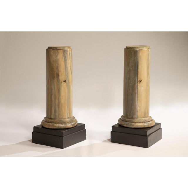 Pair of lacquered Lombard Empire columns, early 19th century. Cylindrical in shape and raised on square bases, they stand...