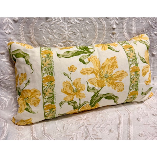A beautifully custom-made lumbar pillow featuring a striking botanical floral stripe in warm golden yellow, fresh leafy...