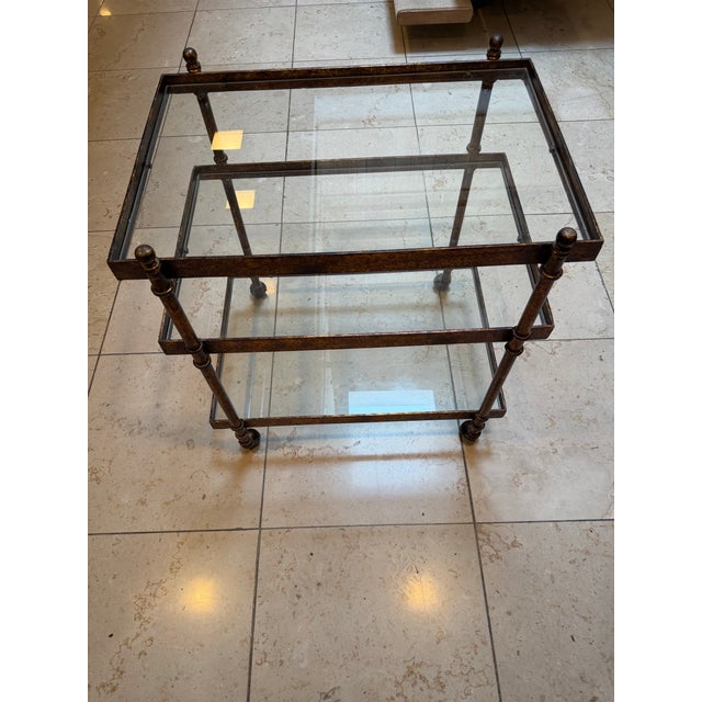 Elegant vintage three-tier bar cart or serving trolley featuring a richly textured faux tortoise finish with inset glass...