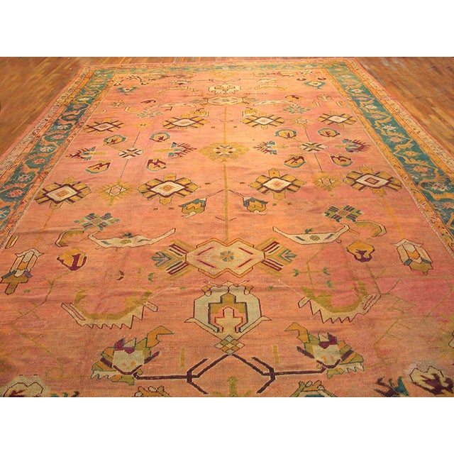 Peach and orange works only on Oushaks. Three explicit columns of small lozenges and geometric flowers and palmettes...