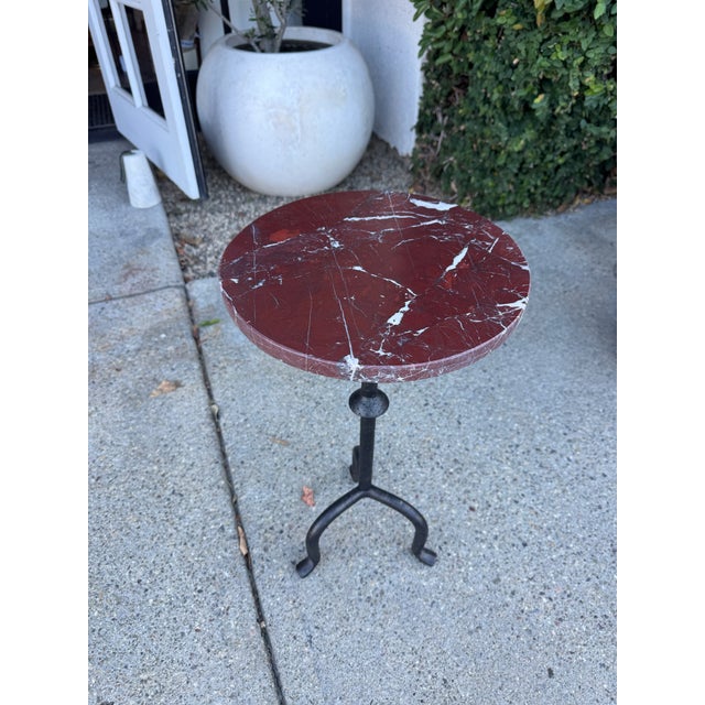 A round top of richly hued marble completes this versatile accent piece, bridging vintage and modern styles. Perfect table...