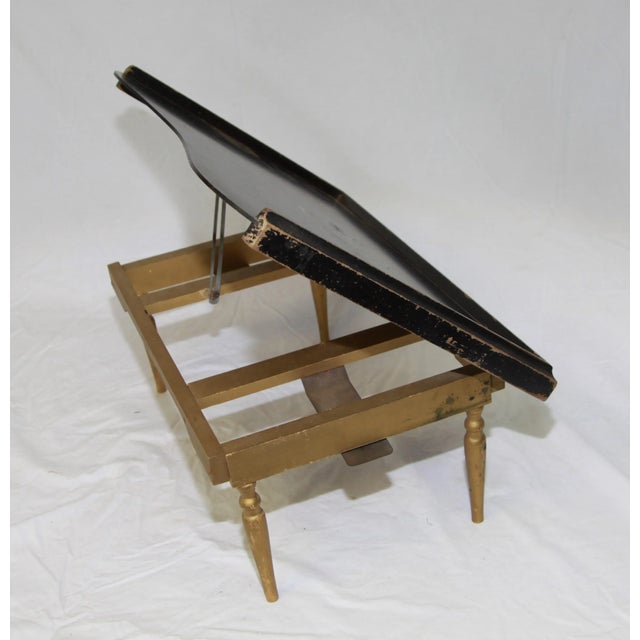 A dainty painted wood breakfast tray with folding legs.