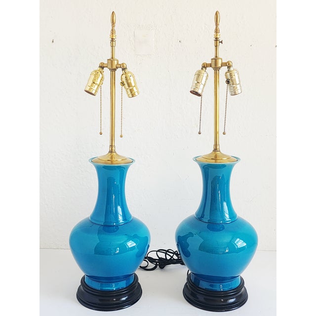 Stunning pair of Century Modern Cerulean blue gourde form porcelain table lamps, with ebonized bases and polished brass...