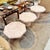 A gorgeous set of three octagonal faux stone pale pink tables, in three different heights, that partially nest below one...