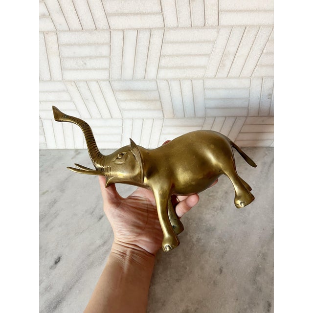 An antique brass elephant. Made in Korea. Measures 8 inches long by 5 wide and 9.5 tall.