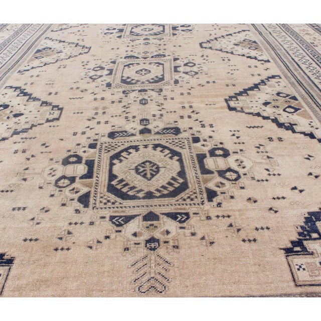 Mid 20th Century Vintage Turkish Oushak Rug Featuring Soft Beige Field With Navy Tribal Design For Sale - Image 5 of 9