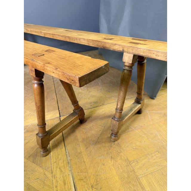 Pair of solid cherrywood benches, turned legs joined by a stretcher. Cherrywood set, circa 1850. Seat width 14cm.