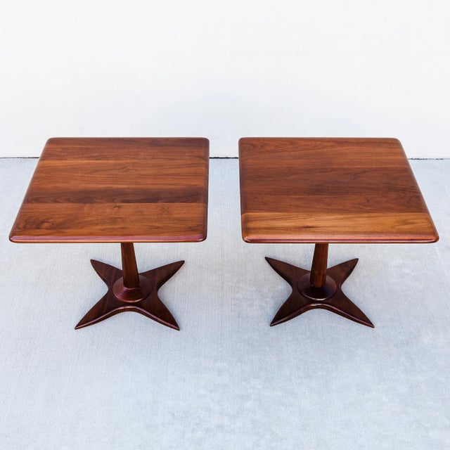 A perfectly restored pair of square end tables, constructed from solid American walnut. The top rests on a Kagan-esque...