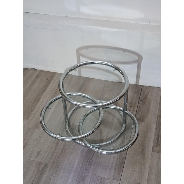Magnificent coffee table with a timeless design. Italy, 1980s. Chrome-plated metal frame. Three thick tempered glass...