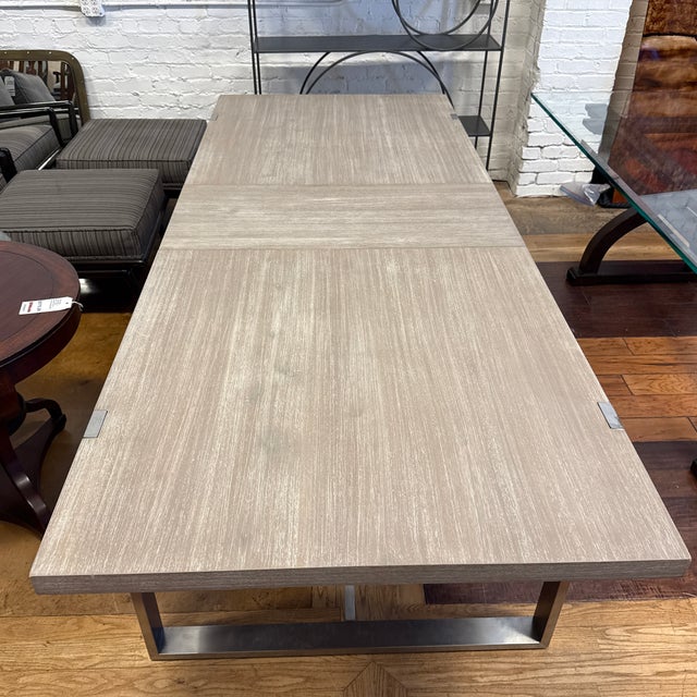 Design Plus Gallery presents a Gage Extension Dining Table from Essentials for Living. The rectangular wood-grain top is...