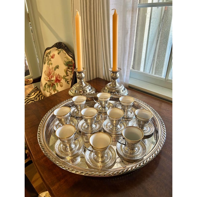 What could be more elegant than after dinner coffee served in sterling silver? This set of 10 demitasse features gold...