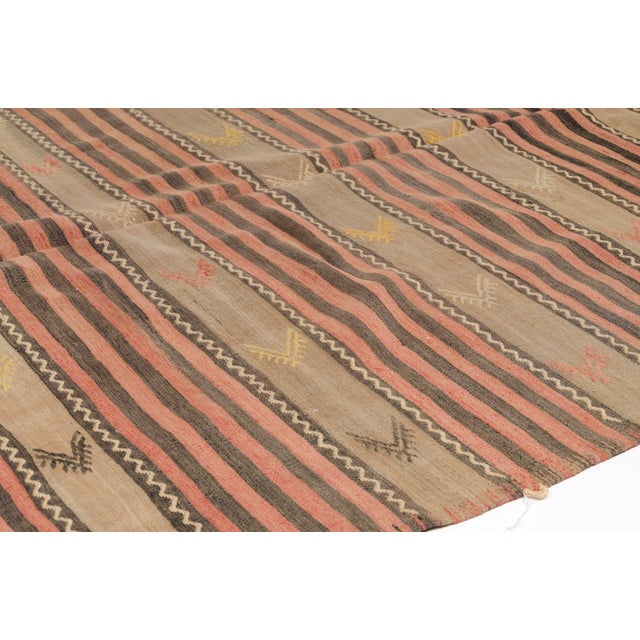This is a vintage Turkish Oushak rug from the Mid 20th Century. The piece was hand-knotted.