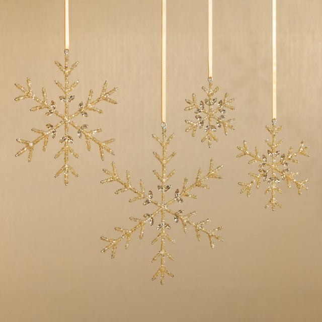 Bring refined sparkle and holiday charm to your seasonal décor with this set of 12 golden snowflake ornaments. Crafted...
