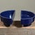 Each vessel is shaped as a half moon with a raised foot and finished in a dark blue glossy glaze. The inscription...