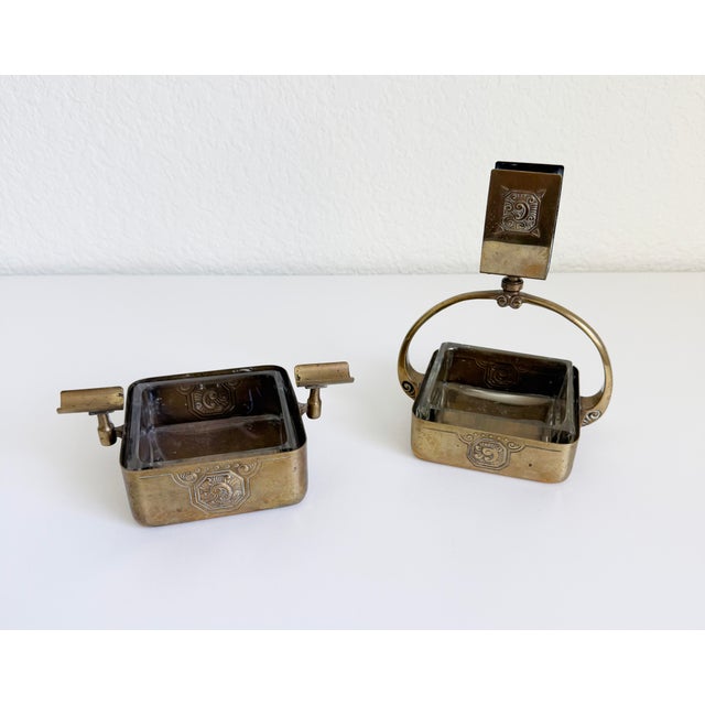 A rare brass and crystal smoking set, including a matchbox holder and ashtray unit, designed to work alongside the resting...