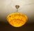large Art Deco pendant light from the 1930s, with a mottled overlay amber glass shade with fire patterns that comes to...