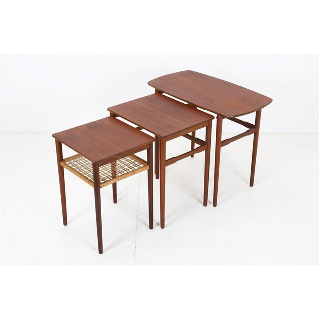 1950s-60s, Denmark. Teak (veneer and solid wood) with a rattan magazine rack. Rare! Tabletops restored and sealed with a...